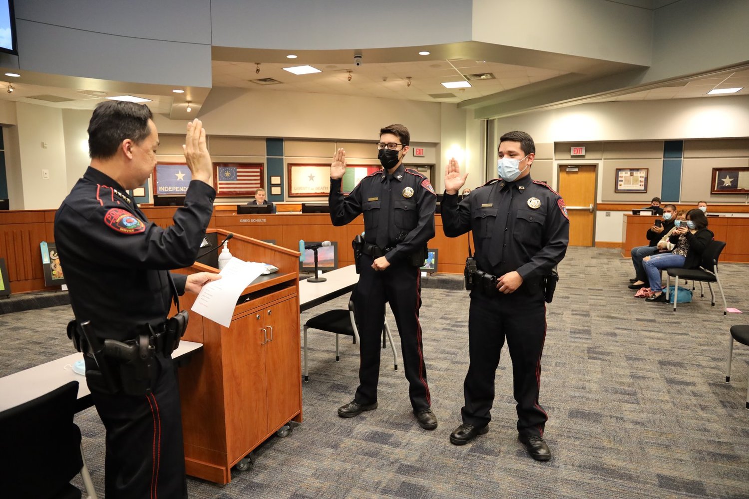 Katy ISD Police Department Officers Timothy Loya (center) and Jose Perez (right) are sworn in by KISD Police Chief Henry Gaw at the district’s Feb. 22 trustee meeting.